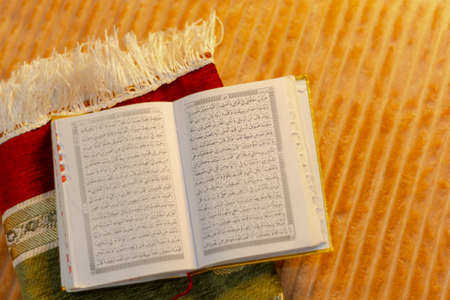 The holy Quran on a wooden background. Ramadan Kareem concept.の写真素材