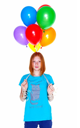 Red-haired girl with colorful balloons on white backgroundの写真素材