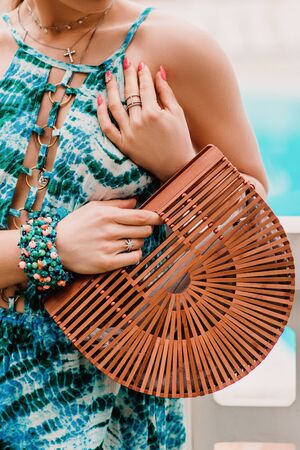 young woman on vacation holding a beach handbag.の写真素材