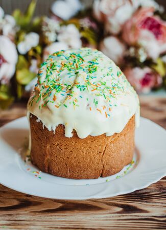Glazed easter cake decorated with colored powder on wooden background. Happy Easter Holidays....