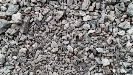 Small stones lie on the road background texture. Photoの写真素材