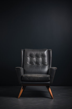 One black leather armchair on a solid dark gray background. Comfortable soft office chair. Modern design. Cozy expensive luxury furniture. Advertising, booklet, poster, furniture store. Home interiorの素材