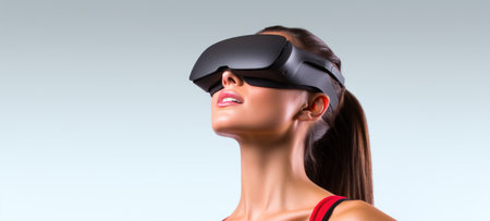 Caucasian brunette woman in virtual reality glasses on a white background. With cope space. Banner template of Person in black VR goggles. Concept of technology, game, entertainment, artificial intelligence.の素材