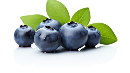Fresh Blueberry on White Background. Close up of Blue berries with green leaves. Delicious healthy dessert rich in vitamins and minerals. Eco product. For label, poster, brochure, food blogの素材