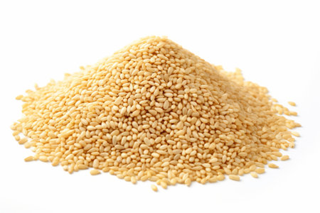 White sesame seeds in a heap, isolated on a white background, ideal for culinary and food concepts.の素材