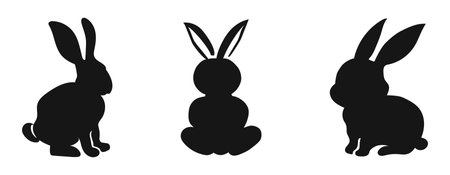 Set of black silhouettes of rabbits isolated on a white background. Easter bunny. Toy hare. Concept of cute animal illustration, minimalist style, and toy pet. Design element, icon, print, and logo.のイラスト素材