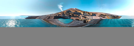 Panoramic view of a volcanic island surrounded by clear blue waters. Concept of natural beauty, volcanic landscapes, pristine beaches, scenic vacation destinations.の写真素材