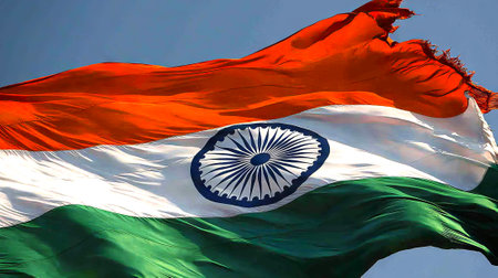 Indian Flag Waving Under a Clear Blue Sky, Celebrating Republic Day. Concept of Patriotism, National...
