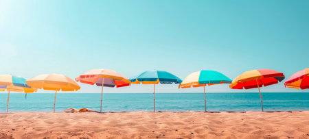 Colorful beach umbrellas on sandy shore. Multiple beach umbrellas by the sea. Concept of beach resort, summer vacation, sun protection, and leisure. Banner. Copy spaceの写真素材