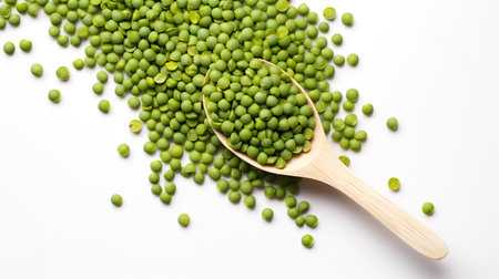 Green peas in a wooden spoon on a white background. Heap of fresh green peas with a spoon. Concept...