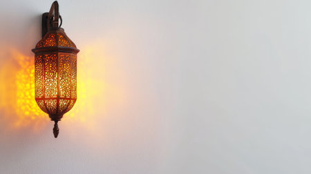 Traditional ramadan lantern with intricate islamic design casting warm glow on wall. concept of cultural heritage, spiritual reflection, festive decoration, middle eastern art. Copy space.の写真素材