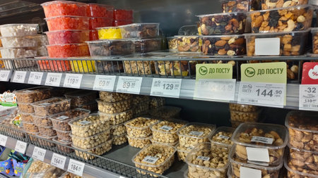 Dnipro, Ukraine - April 09, 2025: Supermarket shelf display of various nuts and dried fruits....