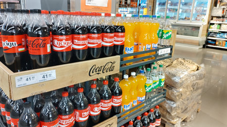 Dnipro, Ukraine - April 09, 2025: Variety of Coca-cola soda bottles on store shelves. concept of...