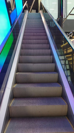 Colorful modern escalator in shopping mall. concept of urban architecture, contemporary design,...
