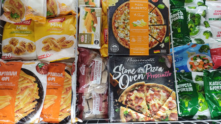 Dnipro, Ukraine - April 26, 2025 - Frozen food variety in supermarket freezer displaying assorted pizzas, vegetables, and snacks. concept of convenient meal options, grocery shopping.