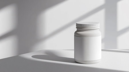 Sleek White Jar for Nutritional Supplements with blank label on Minimalist White Background. Concept of Health Products, Minimalist Design, Wellness Packaging, Modern Nutrition. Mockup, Copy space.の写真素材