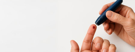 Person conducting blood glucose testing with handheld device on white background. concept of health monitoring, diabetes management, medical device, accurate testing, Banner, copy space.の写真素材