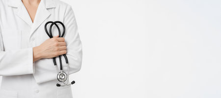 Healthcare male professional doctor holding stethoscope on white background with copy space. concept of medical care, trusted doctor, health service, Wide banner, copy space, white background.の写真素材