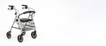 Aluminum rollator walker with adjustable seats and wheels for enhanced mobility and support in daily activities. independence, elderly care, accessibility, Wide banner, copy space, white background.の写真素材