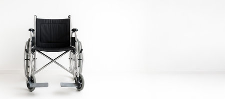 Medical wheelchair front view on white background for healthcare and accessibility solutions in rehabilitation and mobility support, Wide banner, copy space, white background.の写真素材