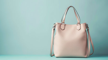 Contemporary fashionable women's handbag against a blue background highlighting modern design and style. concept of fashion accessory, women's fashion, elegance, copy space.の写真素材