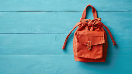 Stylish minimalist backpack on vibrant blue wooden surface. concept of fashion accessory, travel gear, modern style, copy space.の写真素材