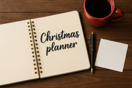 Christmas planner with pen and coffee on wood table for holiday organization. concept of festive planning, seasonal preparation, christmas organization.の写真素材