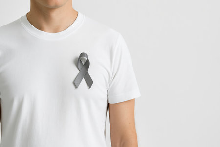 Awareness Gray ribbon display on white t-shirt worn by caucasian man. concept of support, health...