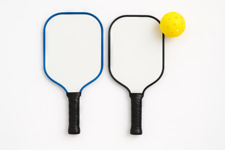 Pickleball paddles and ball on white background. concept of sporting equipment, leisure activity,...