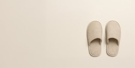 Top view of soft beige home slippers on light background with copy space. Concept of cozy comfort, minimalist lifestyle, indoor footwear, warm relaxation at home, banner, copy space.の写真素材