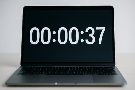Digital countdown timer displayed on laptop screen for time management and productivity concept in modern work environment.の写真素材