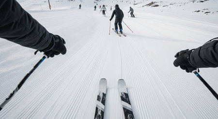 Winter skiing adventure captured from skier's perspective on a snowy mountain slope. concept of outdoor sports, winter fun, and adventure for enthusiasts.の写真素材