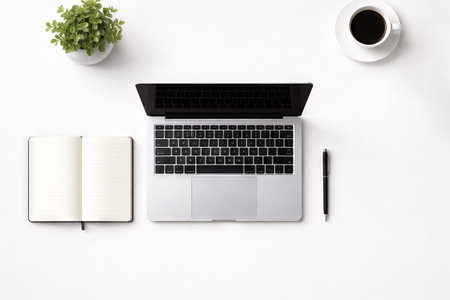 Minimalist home office interior with modern laptop, notebook, pen, coffee, and potted plant on a...