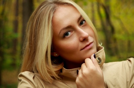 Beautiful woman with green trees. Female white woman fashion photo session in dark scarf flowers...