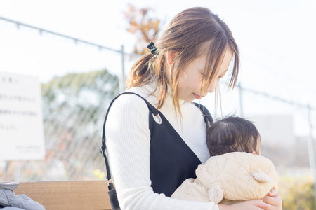 A Japanese woman holding a childの写真素材