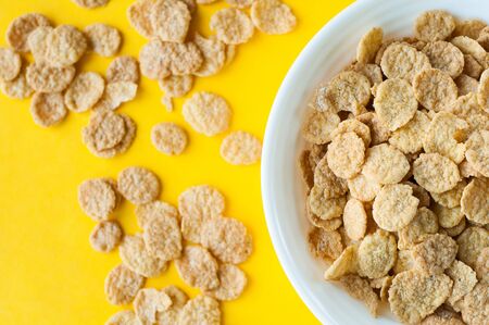 Breakfast pouring milk into corn flakes creating splash apple and orange fruit cookies