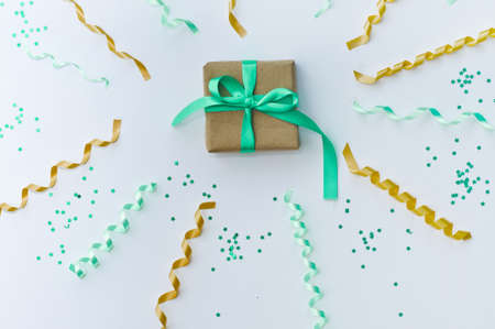 Christmas card with a red ribbon gift box and gold stars, serpentine on a white background knitted sweater. Copy space. Flat layの写真素材