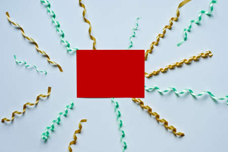 Christmas card with a red ribbon gift box and gold stars, serpentine on a white background knitted...