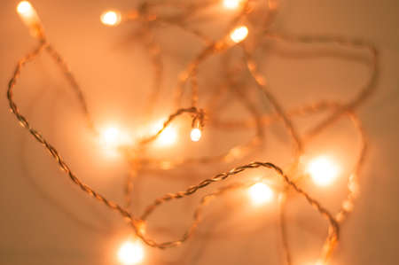 Messy Christmas lights on white background. festive mood, lights and light blurred backgroundの写真素材