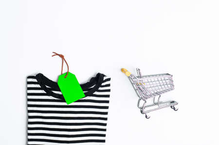 Stack of different polo shirt pants with shopping tag on white color background. Black Friday. view...