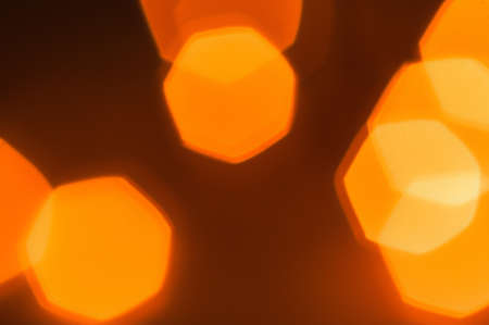 A blurry background of small yellow lanterns on a thin garland burns with a gentle light in a wicker brown wooden basket made of vines. Magical fairy-tale holiday or Christmasの写真素材