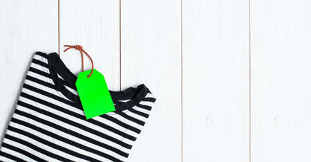 Stack of different polo shirt pants with shopping tag on white color background. Black Friday. view from above.の写真素材