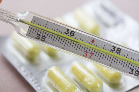 Thermometer, temperature 36.6 and tablets
