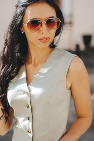 portrait of a beautiful young woman 29 years old with dark long hair on a summer day in sunglasses.