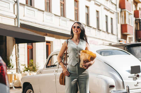 portrait of a beautiful young woman 29 years old with dark long hair on a summer day in sunglassesの写真素材