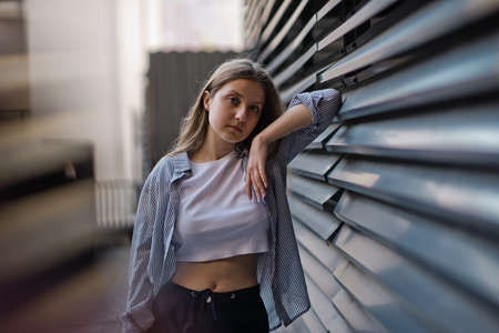 feeling of joy. Young student with some folders poses on university campusの写真素材