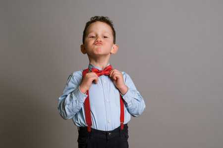 Funny child asking. School boy with hands together in prayerの写真素材