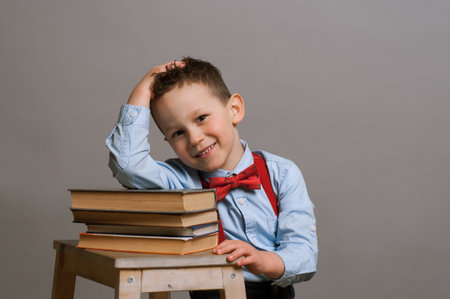 Elementary aged boy sitting at the desk with booksの写真素材