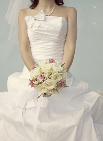 Bride in a white dress with a wedding bouquetの写真素材