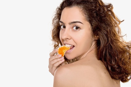 beautiful young girl eating an orange
